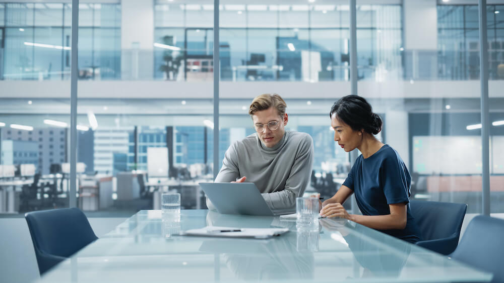 Businessman and woman discussing in a conference room